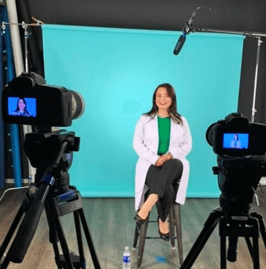 Dr. Nelli Gluzman in front of cameras during a studio recording